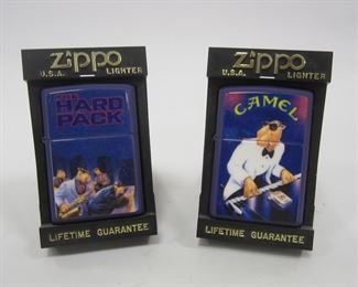 TWO CAMEL LIGHTERS IN DISPLAY HOLDERS: JOE CAMEL WITH HARD PACK AND JOE CAMEL WITH KEYBOARD. SEALS HAVE BEEN LOOSENED. 1990'S BY ZIPPO