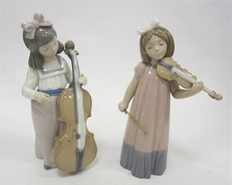 TWO NAO LLADRO PORCELAIN FIGURES OF GIRLS. ONE PLAYING VIOLIN AND ONE WITH CELLO. CELLO PLAYER IS 7" TALL. 1987