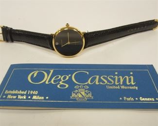 OLEG CASSINI QUARTZ WOMEN'S WATCH. NEW WITH CASE, PAPER WORK AND TAGS