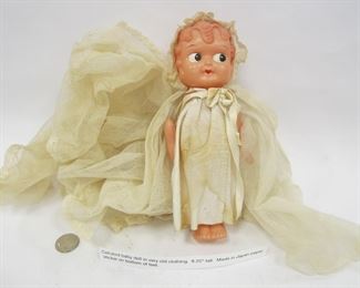 CELLULOID BABY DOLL IN VERY OLD CLOTHING. 8.25" TALL. MADE IN JAPAN PAPER STICKER ON BOTTOM OF FEET