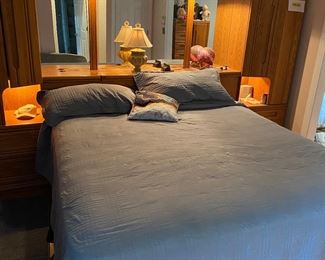 Huge bed with huge headboard complex.