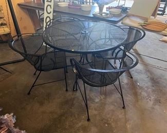 WROUGHT IRON PATIO TABLE AND FOUR CHAIRS