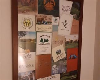 There are many framed souvenirs of golf courses, hanging in the basement family room.