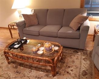 Sitting area behind the fireplace on the main floor.  These pieces are Flexsteel.  Gray/blue color.  Coffee/wine table and matching side table are bamboo and glass.