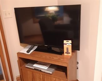 Samsung smart TV (will measure today), Amazon firestick, Toshiba DVD player.  Sitting area behind fireplace.