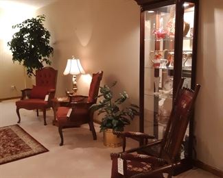 Needlepoint antique rocker, burgundy armchairs and lighted curio, main floor living room.  This is also the room you will checkout in.  