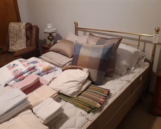 Brass frame Queen sized bed by Lebeda, main floor bedroom to the right of the entryway.