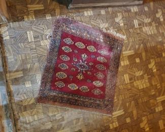a small bakhara rug in need of cleaning