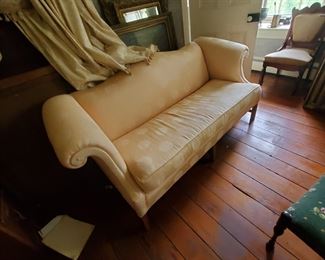 antique camel back sofa, silk upholstery, classic and in good condition, custom drapery