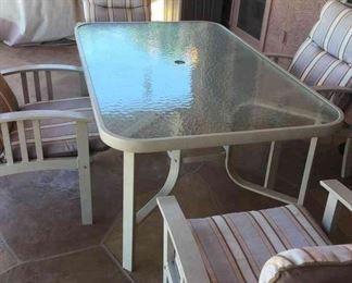 Glass Top Patio Table And Four Metal Chairs With Cushions 