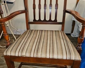 One of two captains chairs that go with the dining table. There are 4 sides chairs.