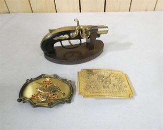 2 belt buckles and a lighter