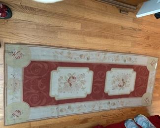 #88	Needlepoint burgundy and cream flowered rug 74.5x29	$75 
