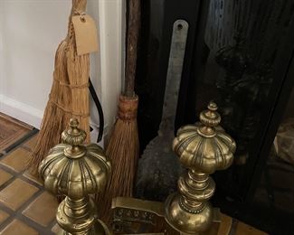 Brass andirons and vintage fireplace brooms