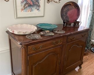 Glick pottery, Sideboard, brass candle sconces and framed watercolor