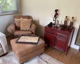 Leather armchair and ottoman, Asian-styled storage chest with 2 drawers, circa late 18th century "military puppet" and western rancher figurines