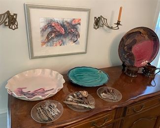 Glick pottery, large pottery platters, silver-plated service/appetizer spoons and forks, framed watercolor and brass candle sconces