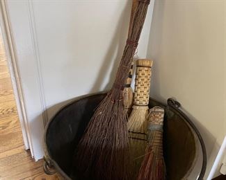 Copper kettle and antique fireplace brooms