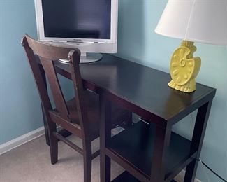 Student desk with side bookcase, wood desk chair, ceramic lamp and monitor