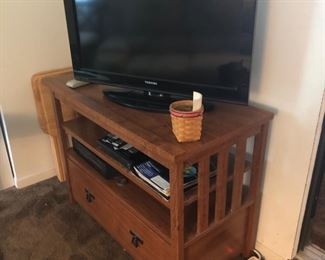 Wood media stand with storage drawers.  Tv.  Longaberger basket, I think there are more in a closet.