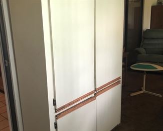 Large storage cabinet currently storing kitchen items