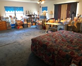 View of the very large upstairs bedroom/sewing/craft/workroom.  All work tables, lamps, supplies, cabinets, shelves, fabric and tools are for sale.  All of the supplies will be unpacked and displayed in the next couple of weeks.  