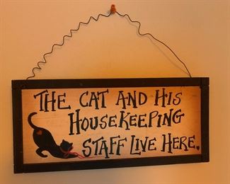 "The Cat and His Housekeeping Staff Live Here" Sign