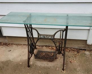 Glass top table with antique Singer sewing base