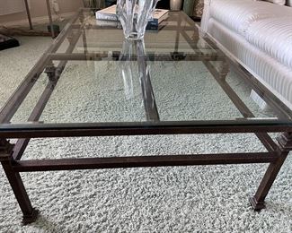 Large glass top on metal stand coffee table