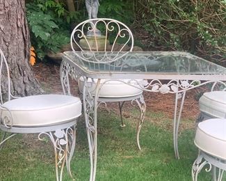 Vintage wrought iron glass top table and four chairs