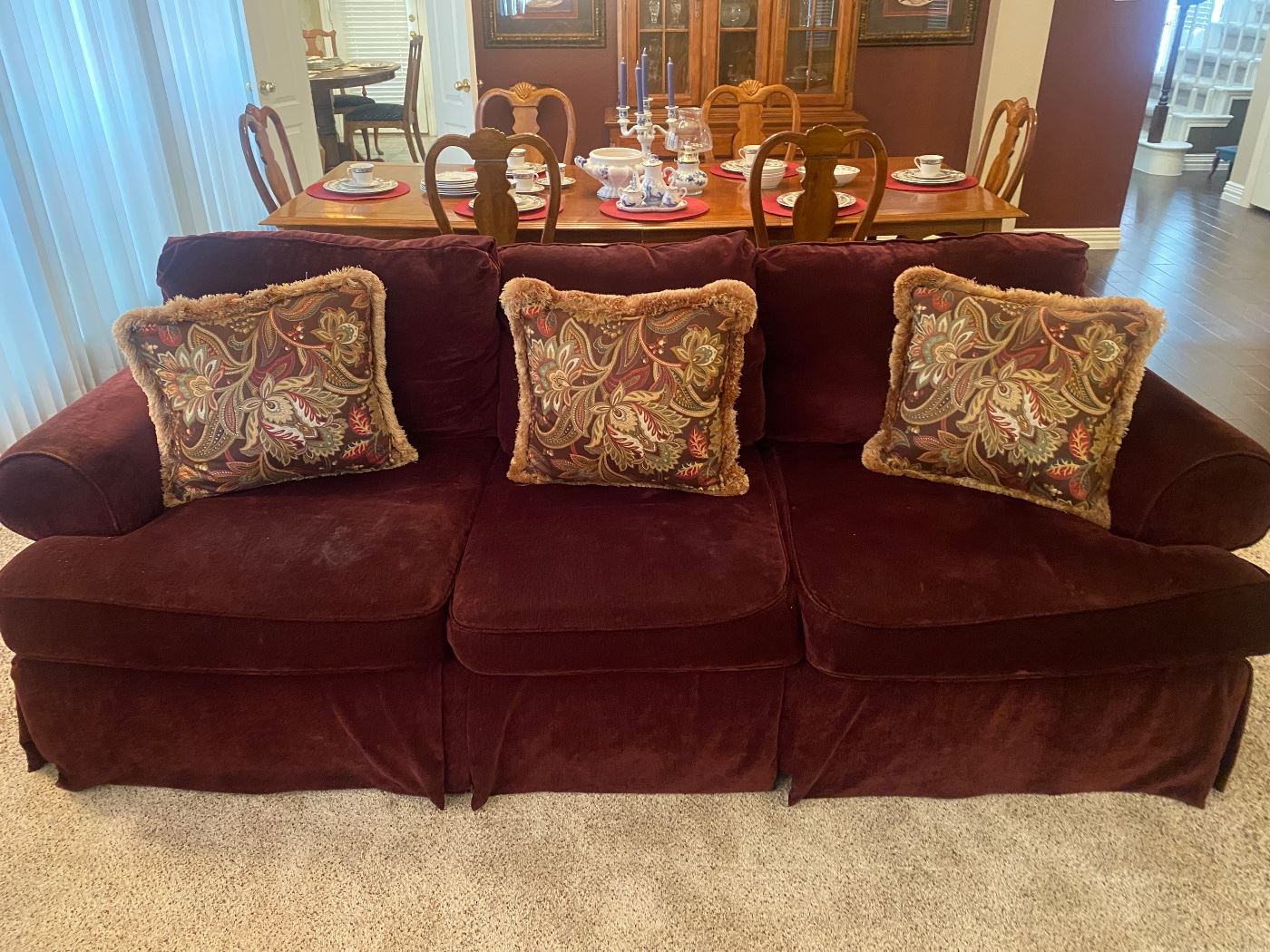 Nice wine colored velvet couch in perfect condition and very comfortable!!