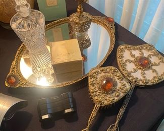 Very unique vanity set includes mirrored tray, brush & hand mirror and a perfume bottle. 