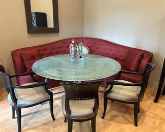 Banquette seating, glass and metal dining table, arm and side chairs