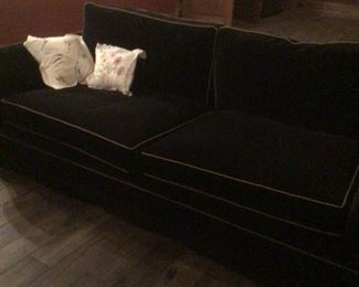 One of three black velour sofas