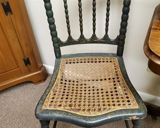 Two lovely, geen and gold painted wicker bottom side chairs.