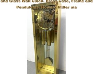 Lot 1791 HOWARD MILLER 39 Tall Brass and Glass Wall Clock. Brass Case, Frame and Pendulums. Howard Miller ma