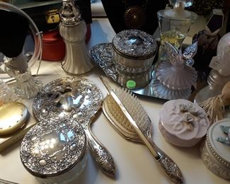 Silver plated and porcelain vanity items, perfume bottles, mirrors, and trinket boxes.