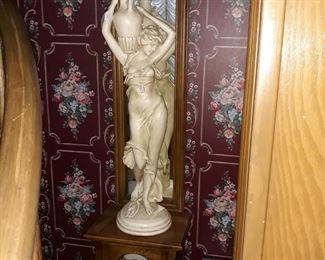 Large chalkware statue and lighted display cabinet with mirror.