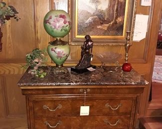 Henredon Charles X chest of drawers, electrified Victorian hurricane lamp, Austin Sculptures bronze, R. Owen original oil painting, and a Hollywood Regency crystal bowl.