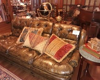 Vintage leather sofa and decorative pillows.