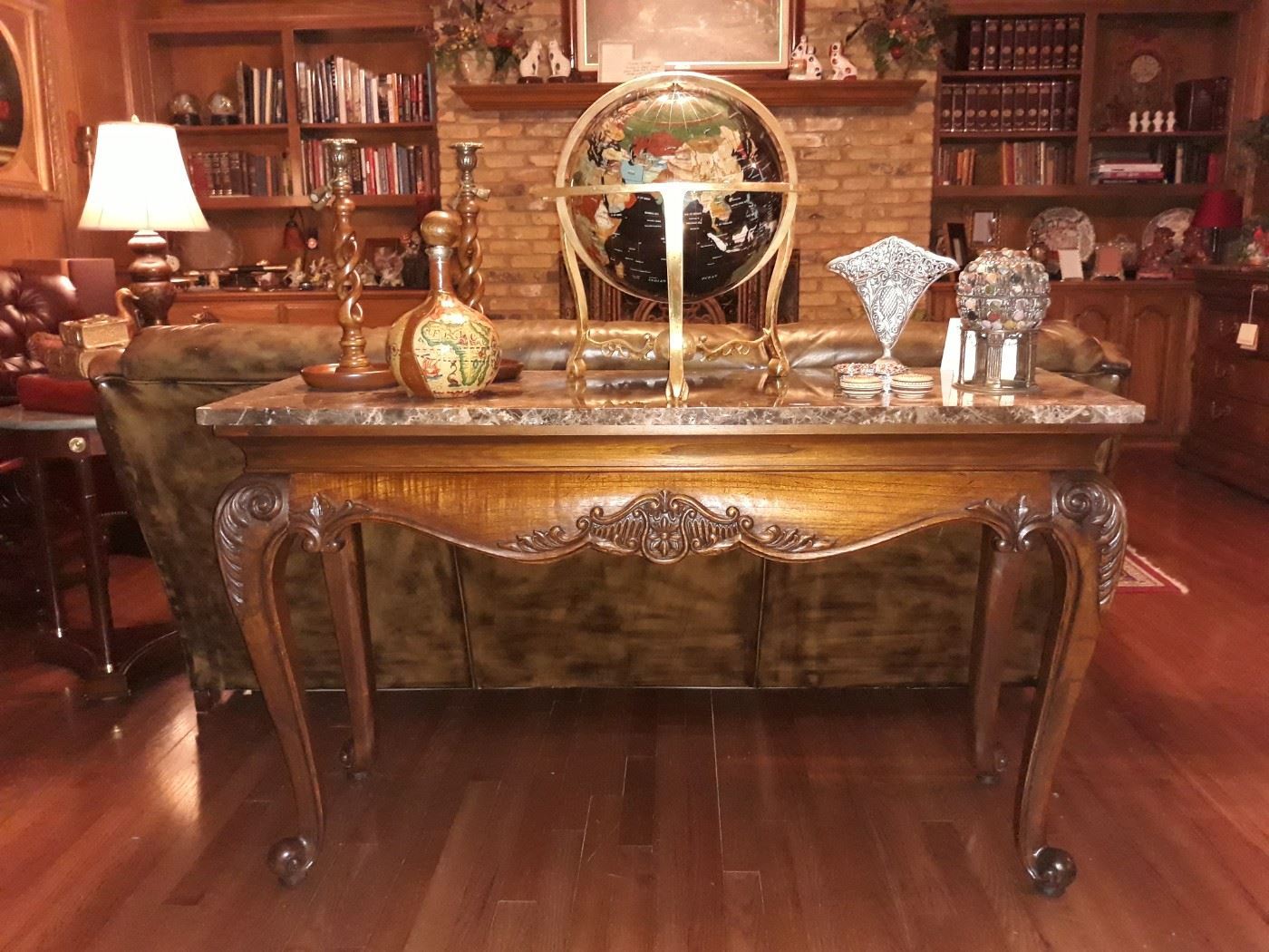 Many beautiful high end traditional furniture and decor from this Heikman console table, lapis globe on brass stand, leather wrapped bottle, barley twist candle holders, and more.