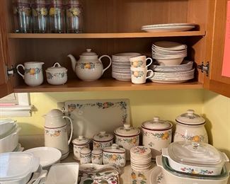 Large set of Corelle Ware Fruit, glasses, cups, bowls plates, saucers, cannisters, s & p, sugar, creamer, tea pot, place mats, casserole dish, cutting board & coffee carafe