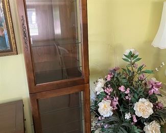 Curio cabinet, tall floral arrangement