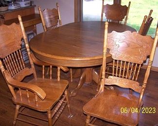 Amish oak dining table and five pressed back chairs