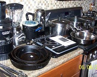 Kitchen ware including Jack Lalanne juicer, cast iron pans, etc...