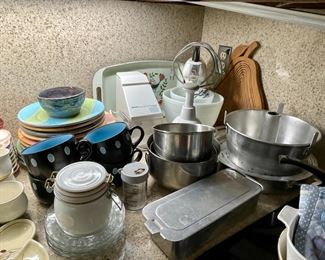 Vintage Hamilton Beach standing mixer amongst the bakeware pieces.