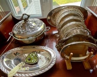 Lots of silver-plated serving plates and chafing dish.