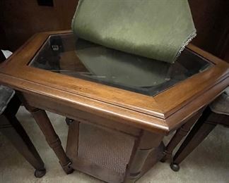 A pentagon shaped glass table with cane bottom shelf.  Lovely!
