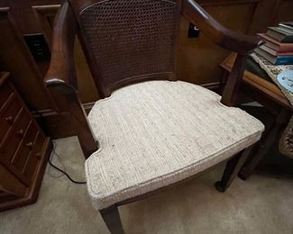 Close-up of one of the Barrel Cane Back Chairs on casters.