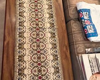 There are a couple of these very unique needlepoint table runners in the home.  Approximately 4' long.